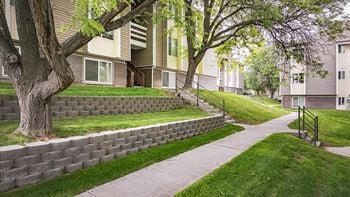 A sidewalk in front of a row of houses
